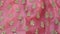 Chumki work on a pink lehenga border