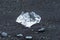 Chunk of ice on black Diamond Beach at JÃ¶kulsÃ¡rlÃ³n glacier lagoon, Jokulsarlon, Iceland