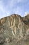 A chunk of mountain, with blue sky, at Knox mountain park in Canada