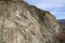 A chunk of mountain, with blue sky, at Knox mountain park in Canada