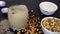 Chunks of ice falling in a glass of Sattu drink decorated with chilies and lemon