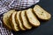 Chunks of whole-grain bread on the dark table.