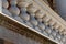 Chunky balusters on an exterior porch with stains and mold underneath, architectural detail