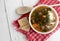 Chunky Italian wedding soup on a light wood background table