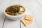 Chunky Italian wedding soup on a light wood background table