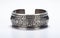 A Chunky Silver Cuff Bracelet with Intricate Tribal Patterns -Generative Ai
