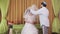 During the chuppah ceremony, the Jewish bride and groom in the synagogue covers the bride's face with a veil