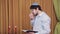 Before the chuppah ceremony, the Jewish groom reads prayers and psalms for siddur in the synagogue hall and makes