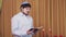 Before the chuppah ceremony, the Jewish groom reads siddur prayers in the synagogue hall