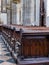 Church aisle with ornamental wooden pews