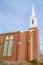 Church with arched windows and white steeple