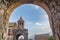 Church through the arches. Religious cultural heritage. Old walls, arch and church