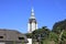 The church bell tower is seen against a blue sky