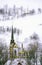 Church with black steeple in winter snow in East Orange, VT