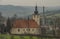 Church in Brumov town in east Moravia with red roof in spring cloudy day