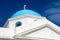 Church building detail Mykonos, Greece. Chapel with cross on blue dome with nice architecture. Agios Nikolaos church on