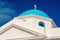 Church building detail Mykonos, Greece. Chapel with cross on blue dome with nice architecture. Agios Nikolaos church on