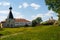 Church and buildings of Kirillo-Belozersky Monastery with green field