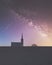 Church chapel silhouette with night sky showing galaxy space and stars with shooting star at St Cyrus Angus Scotland UK