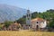 Church with churchyard against mountains. Montenegro, Orthodox church of St. Peter of Cetinje in Prcanj town