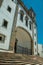 Church facade in baroque style with arched gateway and staircase