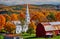 Church and farm with red barn at autumn