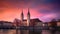 The church Grossmunster. Switzerland. Cityscape image of Zurich with colorful sky, during dramatic sunset, generative ai