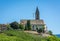 The Church of the idyllic village of Cortaccia. Cortaccia extends on the sunny side of the wine road. South Tyrol, Italy.