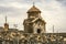 Church of Karmravor in honor of the Blessed Virgin Mary behind a stone fence in the city of Ashtarak