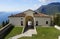 Church Madonna di Montecastello in Tignale on vast lake Garda with scenic Italian Alps in background, Lombardy, Northern Italy