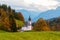 Church of Maria Gern in the mountains in the background with the Watzmann mountains in autumn colors at sunset, Bavaria,