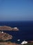 Church monastery on promontory in Aegean Sea with houses and boa