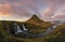 Church mountain and Kirkjufellsfoss waterfall at sunset