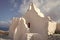 Church of Panagia Paraportiani in Mykonos, Greece. Chapel building with small bell tower. White church architecture on