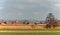 The church with red tower and the fields around the village.Moravia, Czech republic.