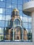 Church reflexion in windows of a modern building