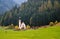 The church of Saint John, Ranui,  Chiesetta di san giovanni in Ranui Runes South Tyrol Italy, surrounded by green meadow, forest