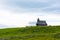 Church in the Slovenia big plateau pasture Velika Planina. Chapel on the hill, religion symbol. Green meadow and blue sky with