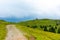 Church in the Slovenia big plateau pasture Velika Planina. Chapel on the hill, religion symbol. Green meadow and blue sky with