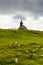 Church in the Slovenia big plateau pasture Velika Planina. Chapel on the hill, religion symbol. Green meadow and blue sky with