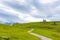 Church in the Slovenia big plateau pasture Velika Planina. Chapel on the hill, religion symbol. Green meadow and blue sky with