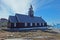 A church in small town of Ilulissat Greenland with a view to Disko Bay and icebergs