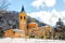 Church snow covered colorful orange yellow