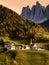 Church of St. Magdalena in front of the Geisler or Odle Dolomites mountain peaks. Val di Funes valley in Italy.