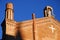 Church with a statue and a white cross on the wall in Bologna in Emilia Romagna (Italy)