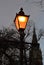 Church steeple behind old-fashioned street lamp