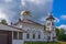 Church to St. Grand Prince Alexander Nevsky in Pudozh after restoration. Orthodox temple and bell tower against northern pine