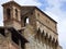 A church on top of a Tuscan hill town stone wall