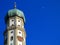 Church tower with onion dome and belfry in rich blue sky