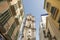 Church tower raising up between classic buildings in the city center of Malaga, Spain.